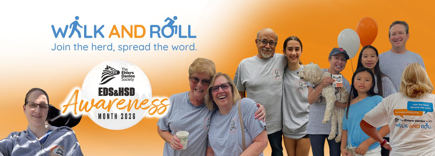 Walk and Roll banner for EDS and HSD Awareness Month 2026 by The Ehlers-Danlos Society. Text reads &lsquo;Walk and Roll: Join the herd, spread the word.&rsquo; A diverse group of community members pose together wearing event shirts, some holding balloons and a small dog, against an orange gradient background.